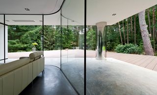 Interior View showing curved wall of glass overlooking the decked area outside