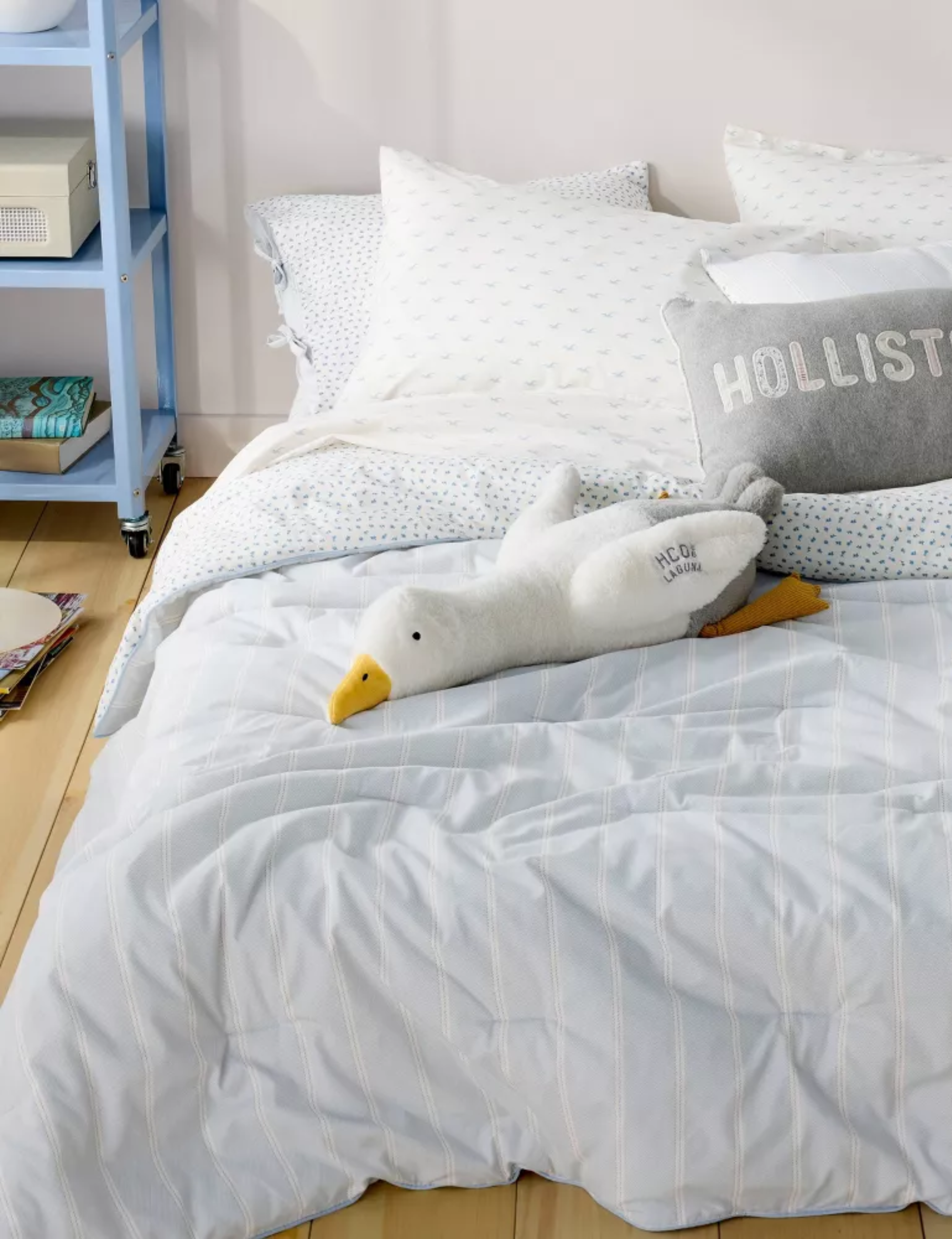 Coastal cool college dorm room bedscape layered with striped and seagull-motif sheets from the new Hollister x Target bedding collaboration