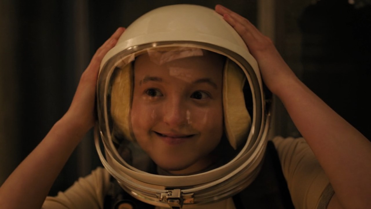Bella Ramsey as Ellie wears a space helmet in The Last of Us Season 2.