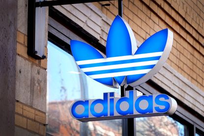 A blue Adidas sign outside a store