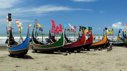 Wooden fishing boats on Cox’s Bazar beach in Bangladesh 