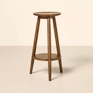 A wooden plant stand from Magnolia