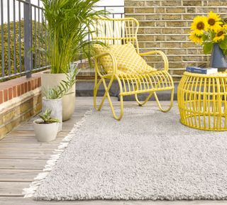 Decked area with outdoor rug and colourful outdoor furniture