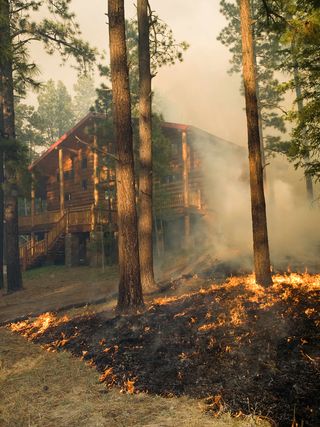Arizona's Wallow Fire threatens a home in 2011.