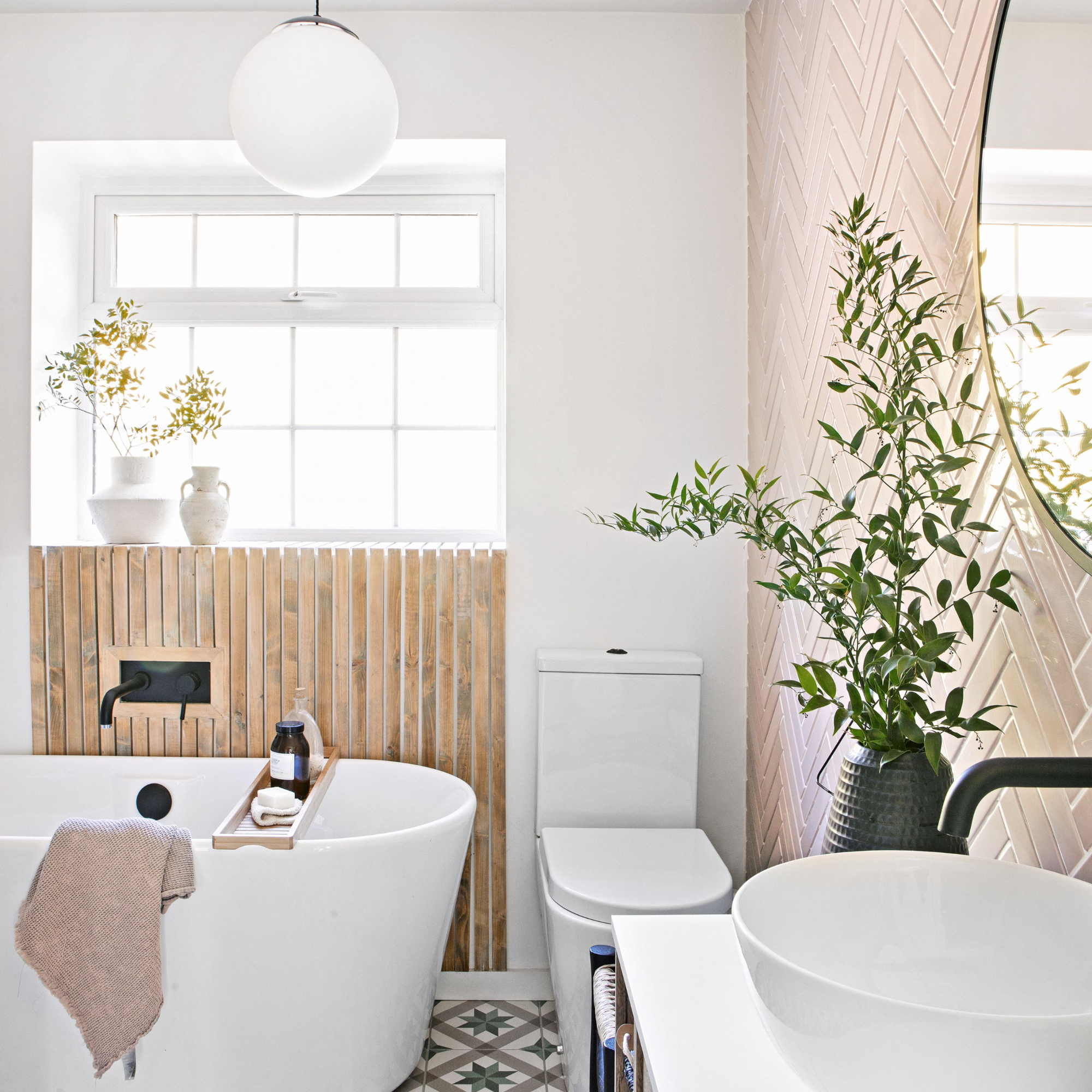 White painted bathroom with tiled accent wall and wooden wall panelling, bathtub and toilet