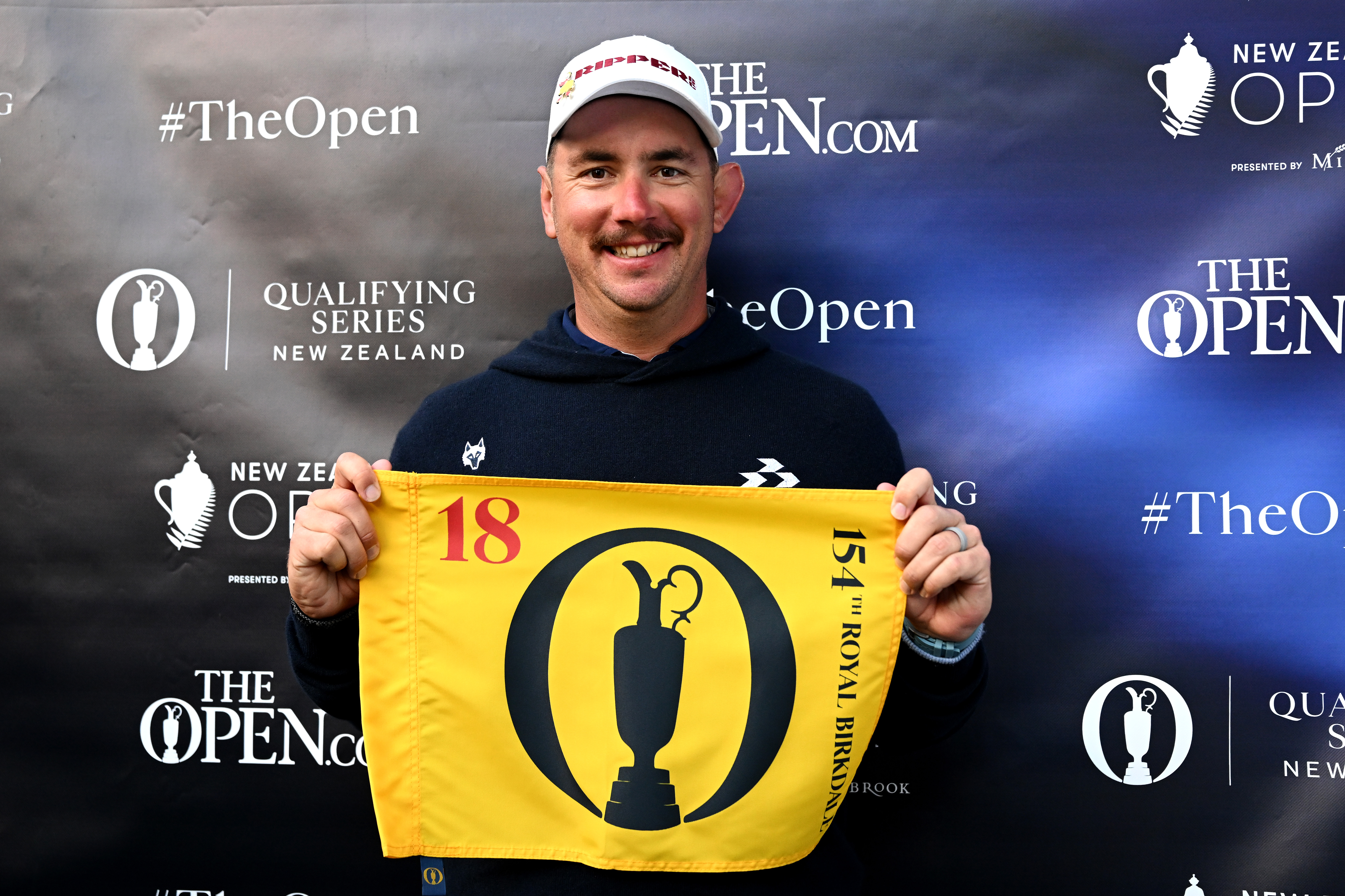 Lucas Herbert poses with an Open Championship pin flag at the 2026 New Zealand Open