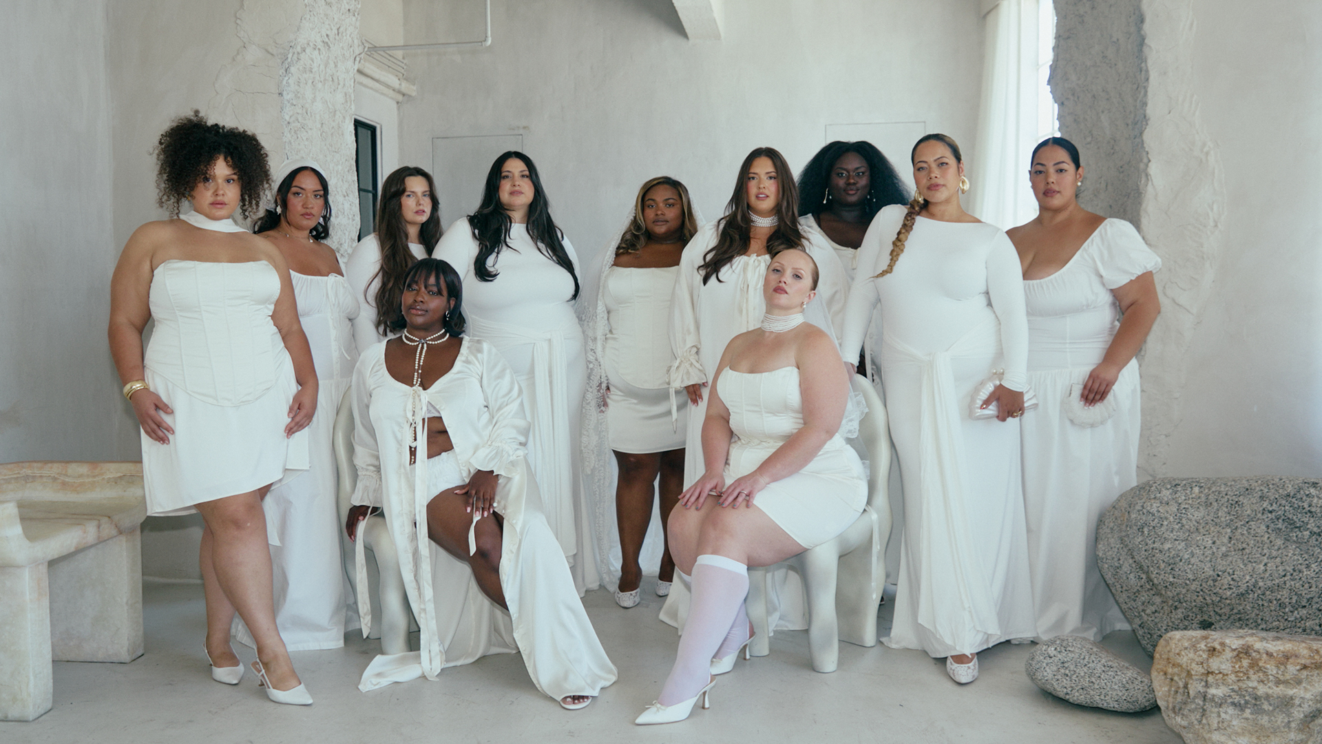 Models wear all white pieces from the collection. 