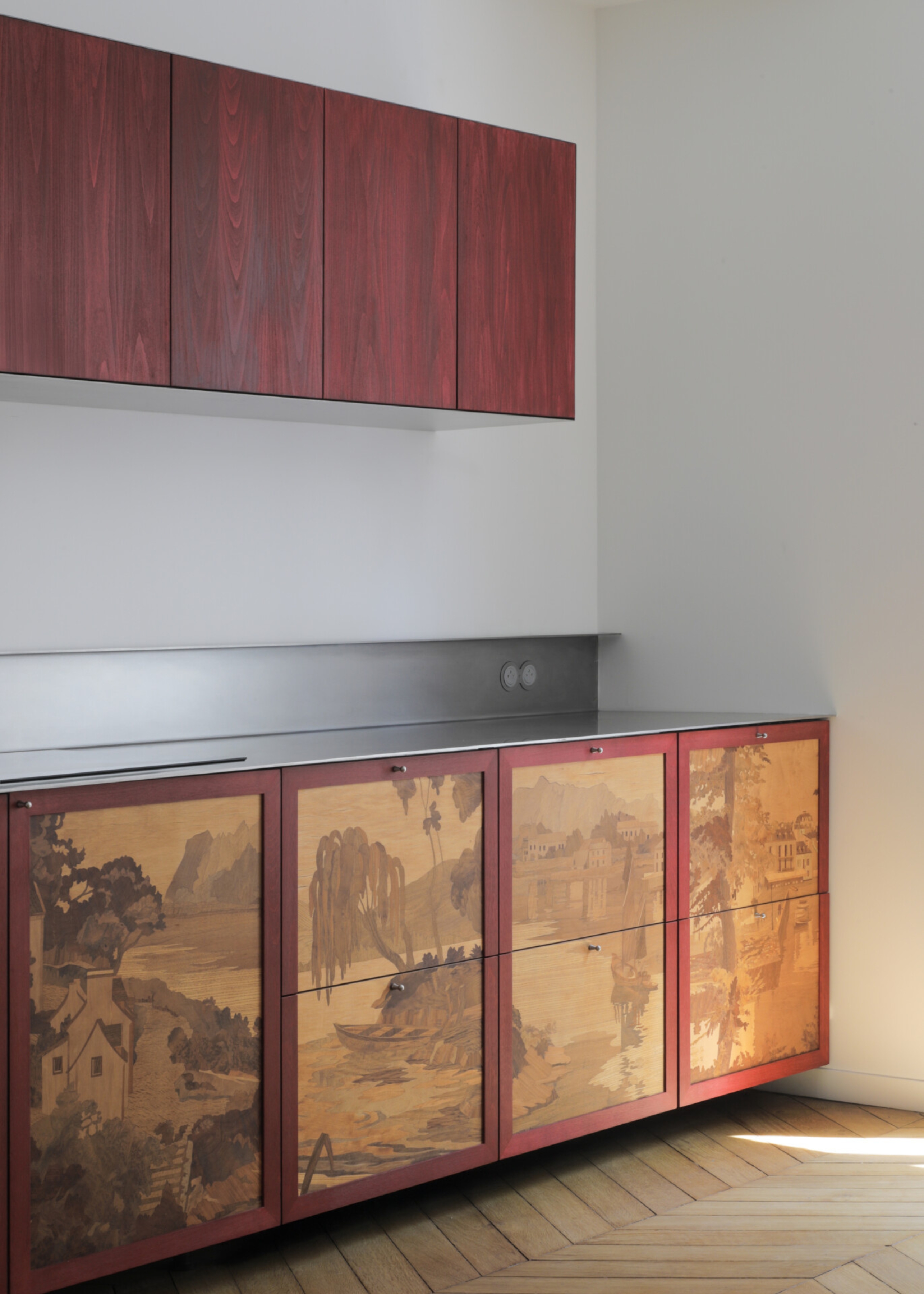 a kitchen with decorative inlaid marquetry in the lower doors, a stainless steel worktop, and a more modern slab door on the upper units
