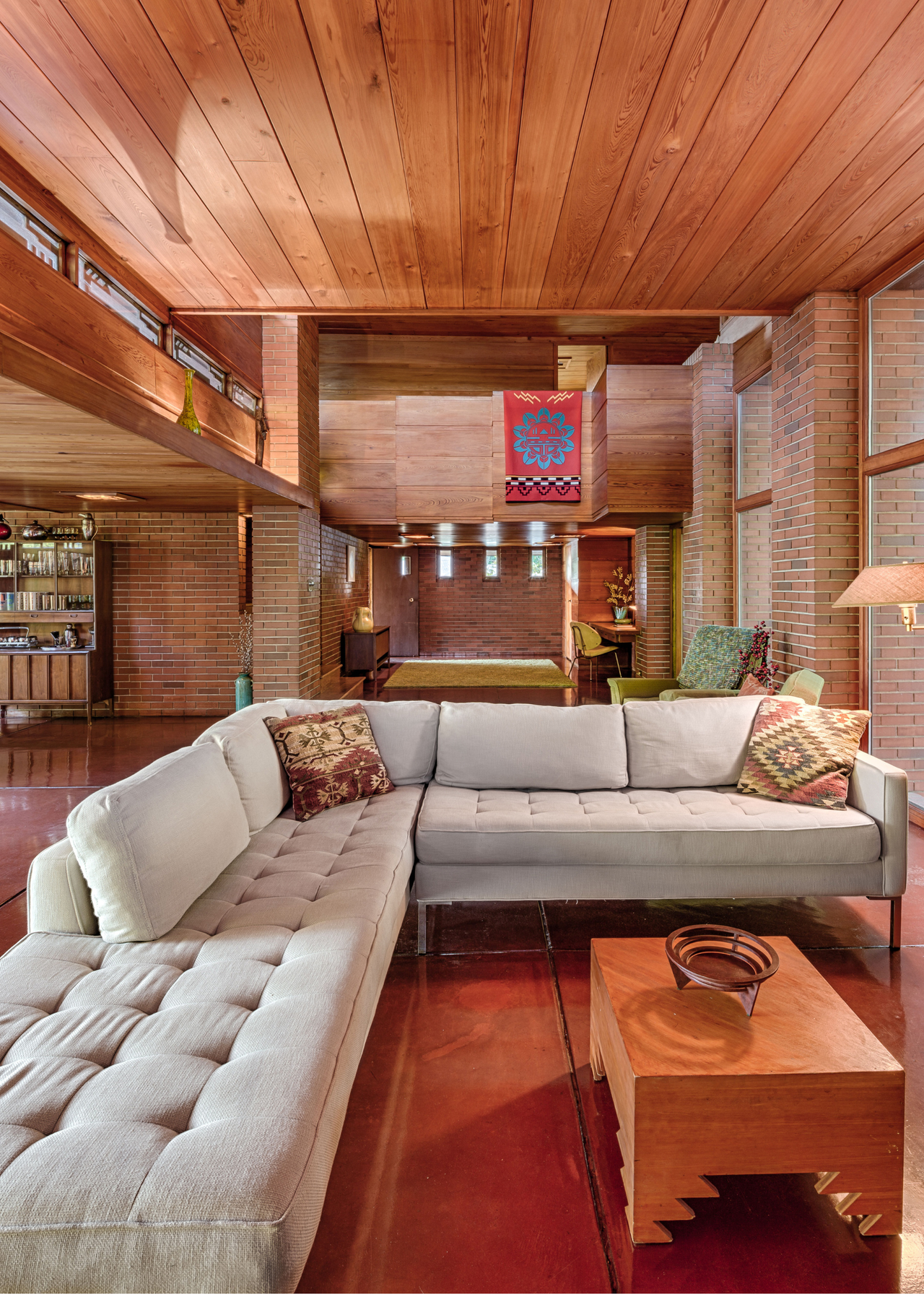 panelled wooden ceiling mid century frank lloyd wright home with an L shaped sofa