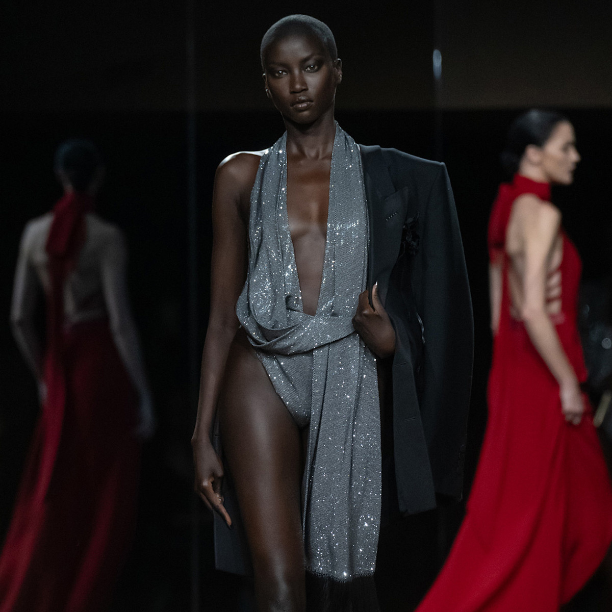 a model at the tom ford shoe wears a sequin bodysuit.