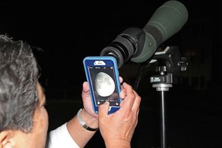 Imelda Joson demonstrates how the afocal projection technique is done using an iPhone 6 and the Swarovski spotting scope that she uses for birdwatching. This is the exact setup used to capture the accompanying photo of the first-quarter moon.