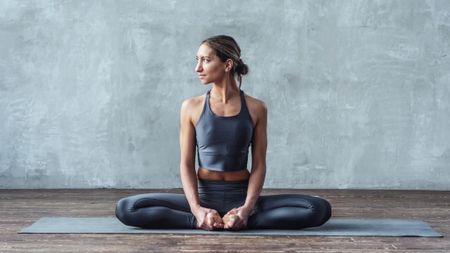 a woman doing the seated butterfly stretch
