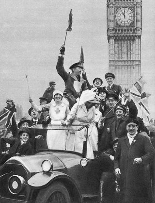 Armistice Day, 11 November 1918, end of the First World War. People celebrating at 11:00 in Whitehall, London after hearing that hostilities had ceased (Photo by Culture Club/Getty Images)