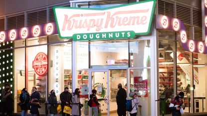 People line up outside Krispy Kreme in Times Square amid the coronavirus pandemic on March 17, 2021 in New York City. 