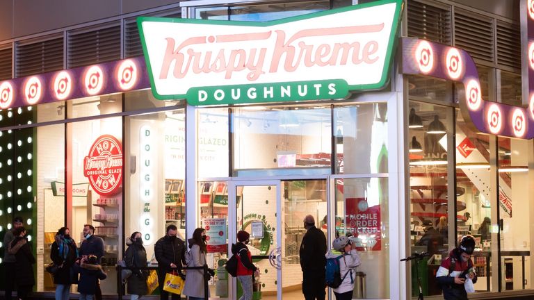 People line up outside Krispy Kreme in Times Square amid the coronavirus pandemic on March 17, 2021 in New York City.