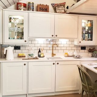 kitchen with storage shelf white tiles and furniture