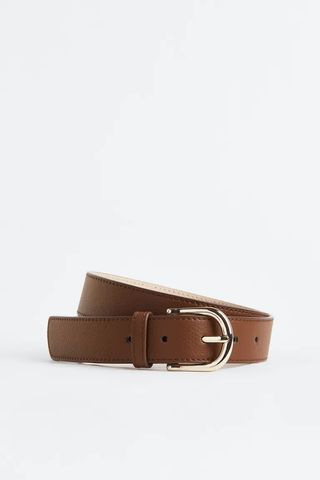 tan belt with gold buckle
