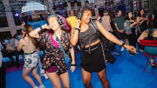 Concert goers dancing at the Silent Disco dance party at Lincoln Center, New York City on Saturday, July 1, 2023.