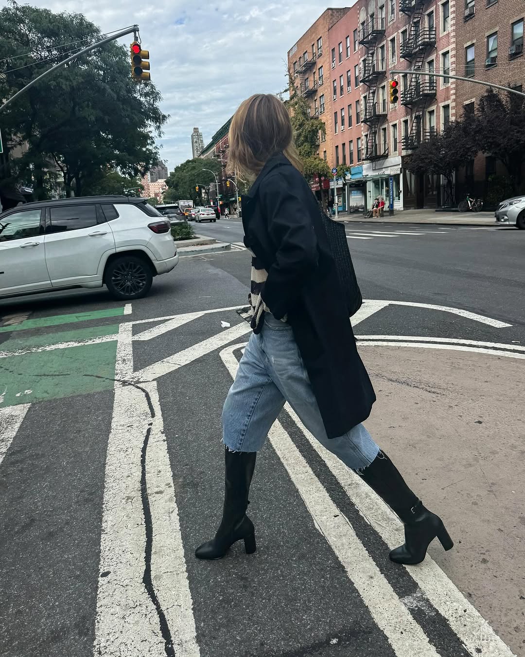 woman wearing knee high fitted boots