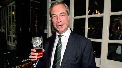 Nigel Farage poses with a pint