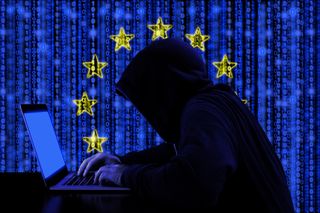 Hacker behind a computer against the EU flag to depict Brexit