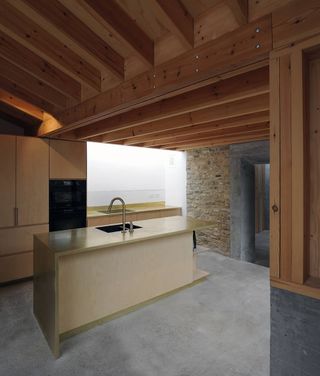 Kitchen with wood panel ceiling and brick wall of Malmesbury House