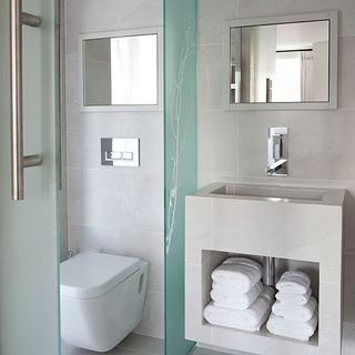 bathroom with glass door and commode