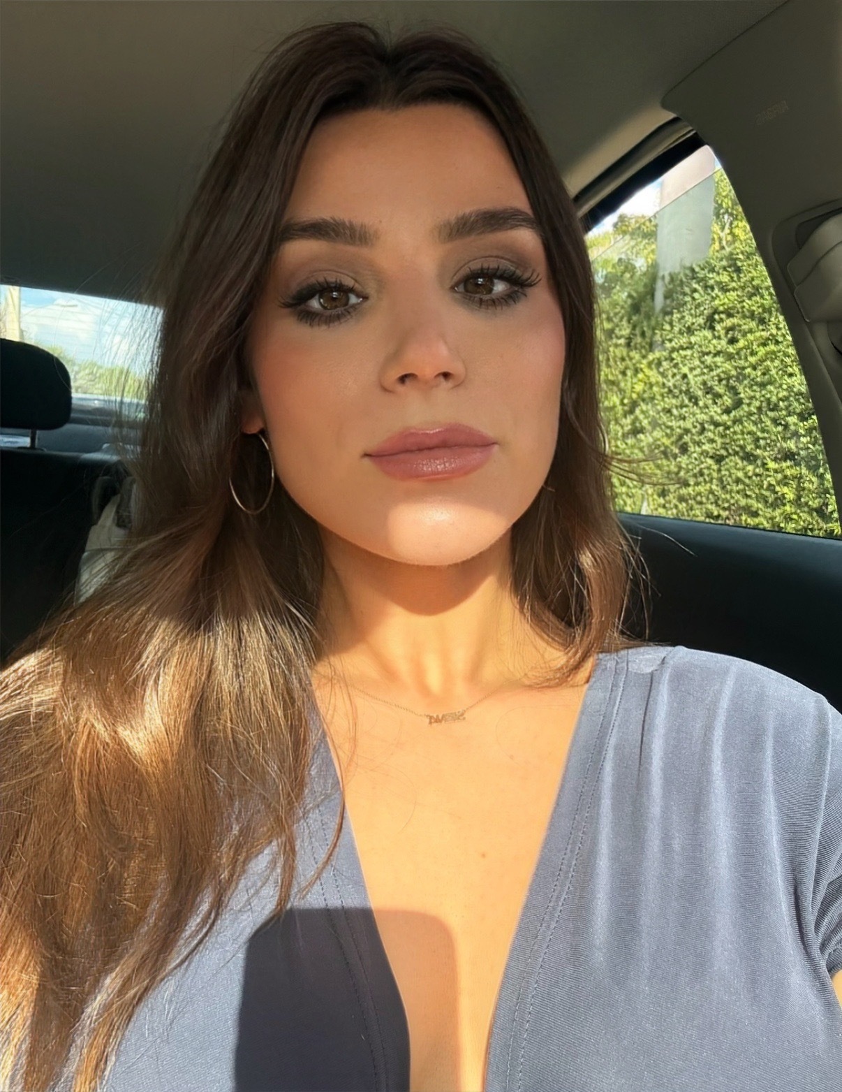 Siena Gagliano with a blue shirt and aussie girl makeup trend and long brown hair