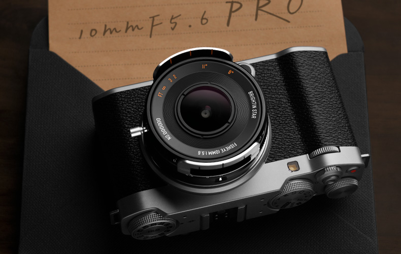 Brightin Star 10mm f/5.6 Pro APS-C on retro camera next to a hand-written note that states: 10mm f/5.6 Pro