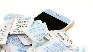 A phone surrounded by silica gel packets