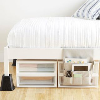 Bed with bedside caddy holding notebooks