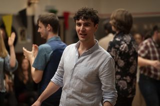 Donnie (Angus Miller), at a party with lots of people in the background drinking and dancing.