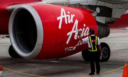 An AirAsia plane is inspected before takeoff