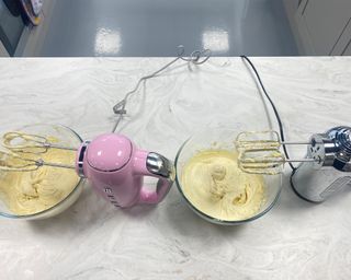 Image of the Dualit hand mixer alongside Smeg hand mixer during testing
