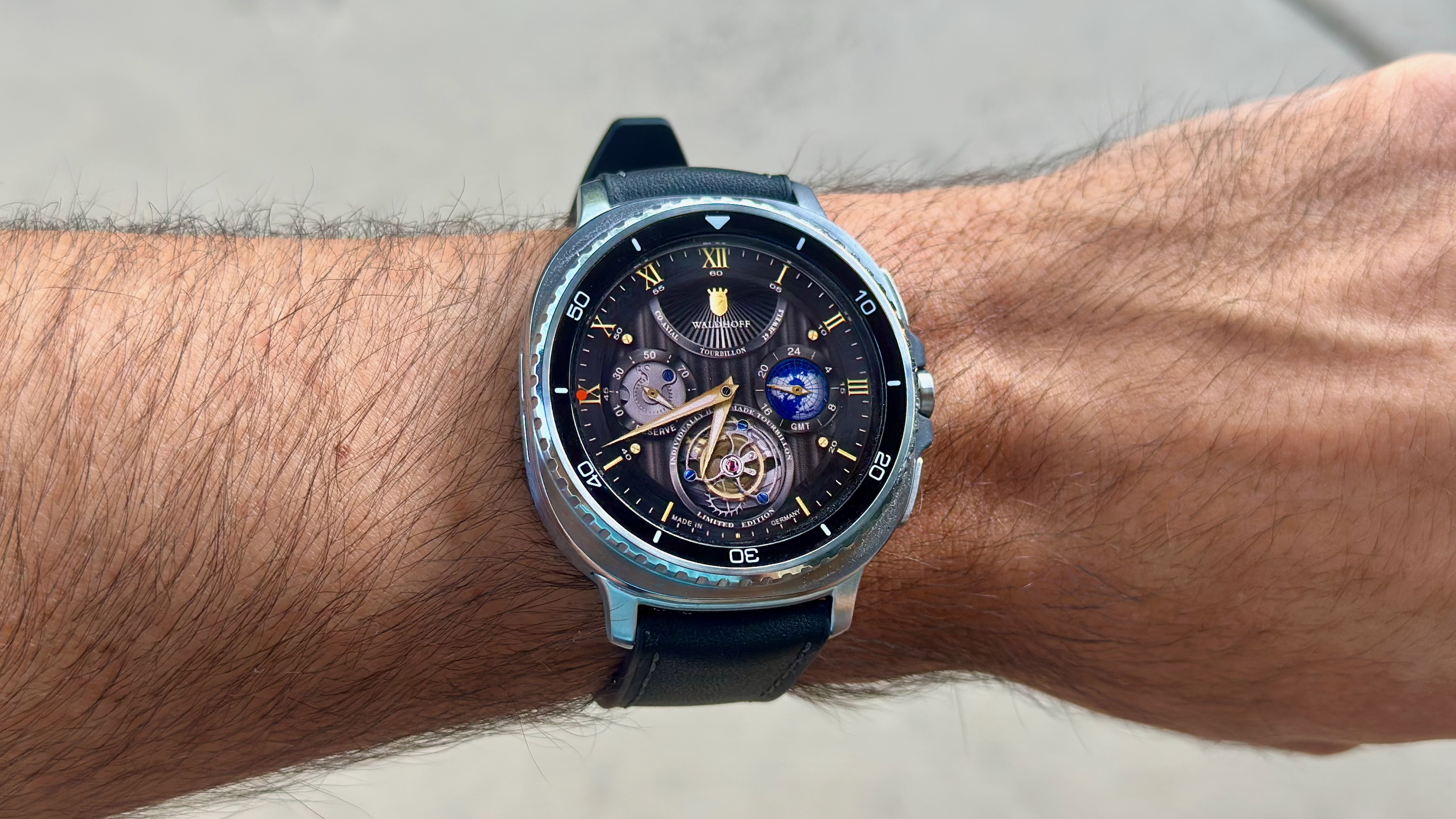 The Samsung Galaxy Watch 8 Classic on a person's wrist, showing a custom watch face from Facer and Waldhoff.
