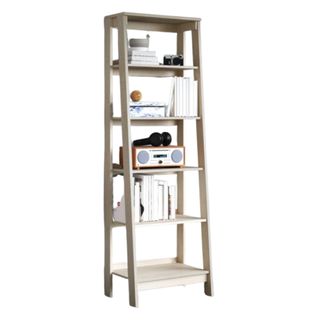 A white ladder bookcase with decor on it