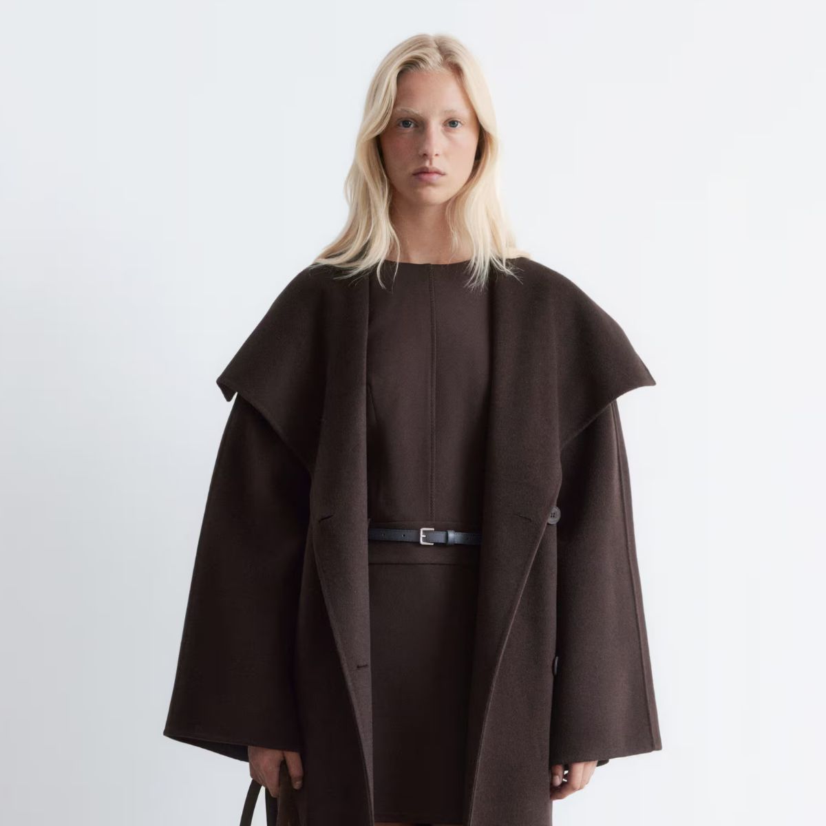 model wearing brown funnel neck COS jacket