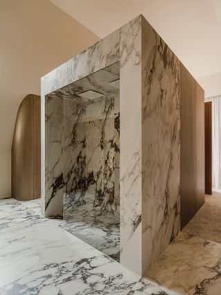 A bathroom with a standalone marble shower