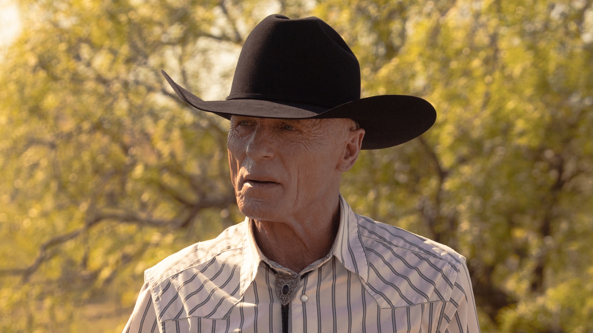 Everett in cowboy hat walking outside with Beulah in Dutton Ranch Season 1