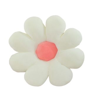 A white daisy shaped throw pillow with a pink circular centre