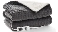 A grey and white quilted electrically-operated throw