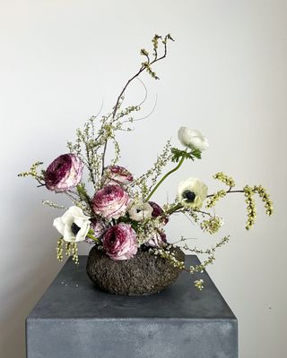 a fresh flower arrangement on a gray pedestal