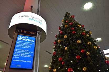 An information board announces flight disruption at London Gatwick Airport, south of London, on December 20, 2018 after all flights were grounded due to drones flying over the airfield.