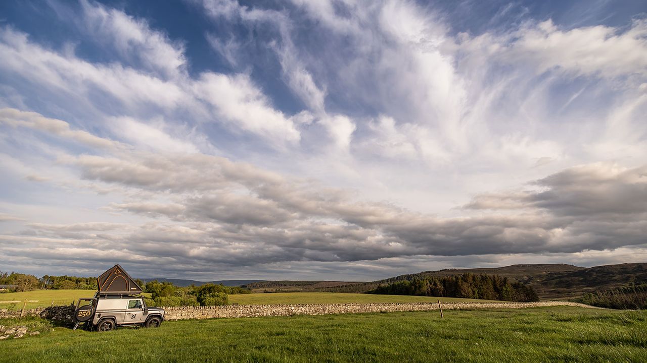 Land Rover campervan in a field 