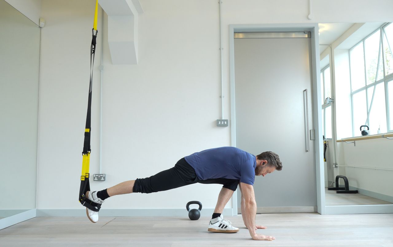 Niko Algieri demonstrates one position of the TRX burpee
