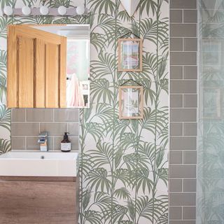 bathroom with wallpaper wall and washbasin