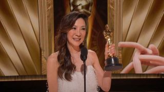Michelle Yeoh holding up her Oscar at the 95th Academy Awards.