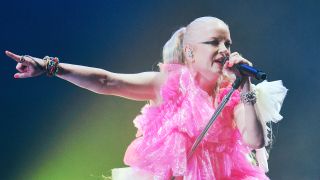 Shirley Manson on stage in a pink dress