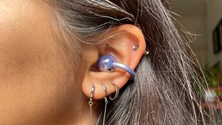 Huawei FreeClip in purple finish placed in ear