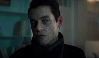 No Time To Die Rami Malek looks to the side, coldly